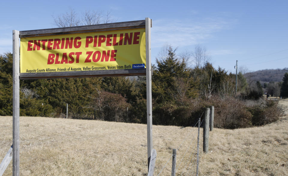 FILE - This Feb. 8, 2018, file photo shows a sign along a highway to protests the route of the Atlantic Coast Pipeline in Deerfield, Va. The developers of the Atlantic Coast Pipeline announced Sunday, July 5, 2020, that they are canceling the multi-state natural gas project, citing delays and increasing cost uncertainty. (AP Photo/Steve Helber, File)