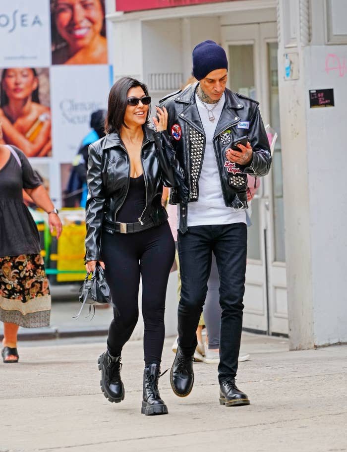 The couple, both rocking leather jackets, walking outside