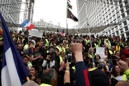 FILE PHOTO: Protesters wearing yellow vests attend a demonstration during the Act XXI (the 21st consecutive national protest on Saturday) of the yellow vests movement at the financial district of La Defense near Paris, France, April 6, 2019. REUTERS/Benoit Tessier/File Photo