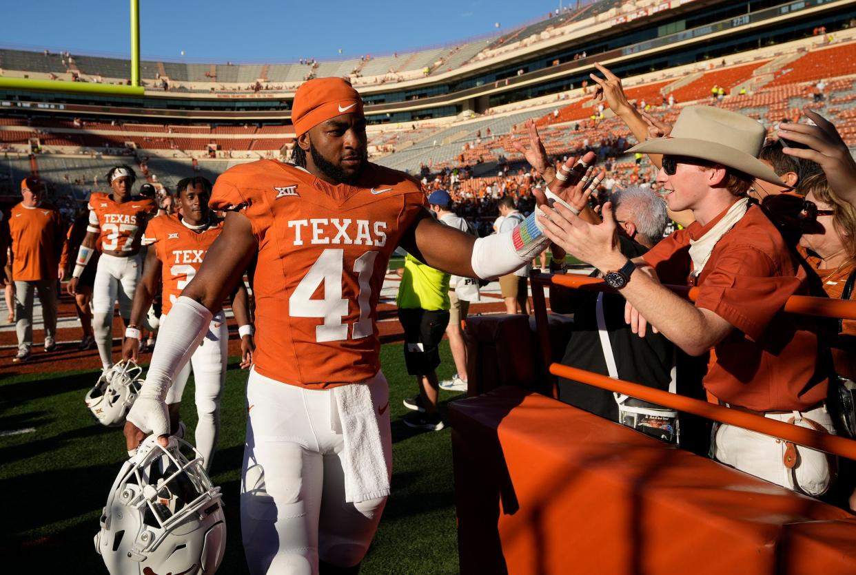 Texas linebacker Jaylan Ford celebrates with fans after the Longhorns beat Kansas earlier this season in a top-25 matchup at Royal-Memorial Stadium. Ford and the Texas run defense will face a stern test Saturday against Kansas State.