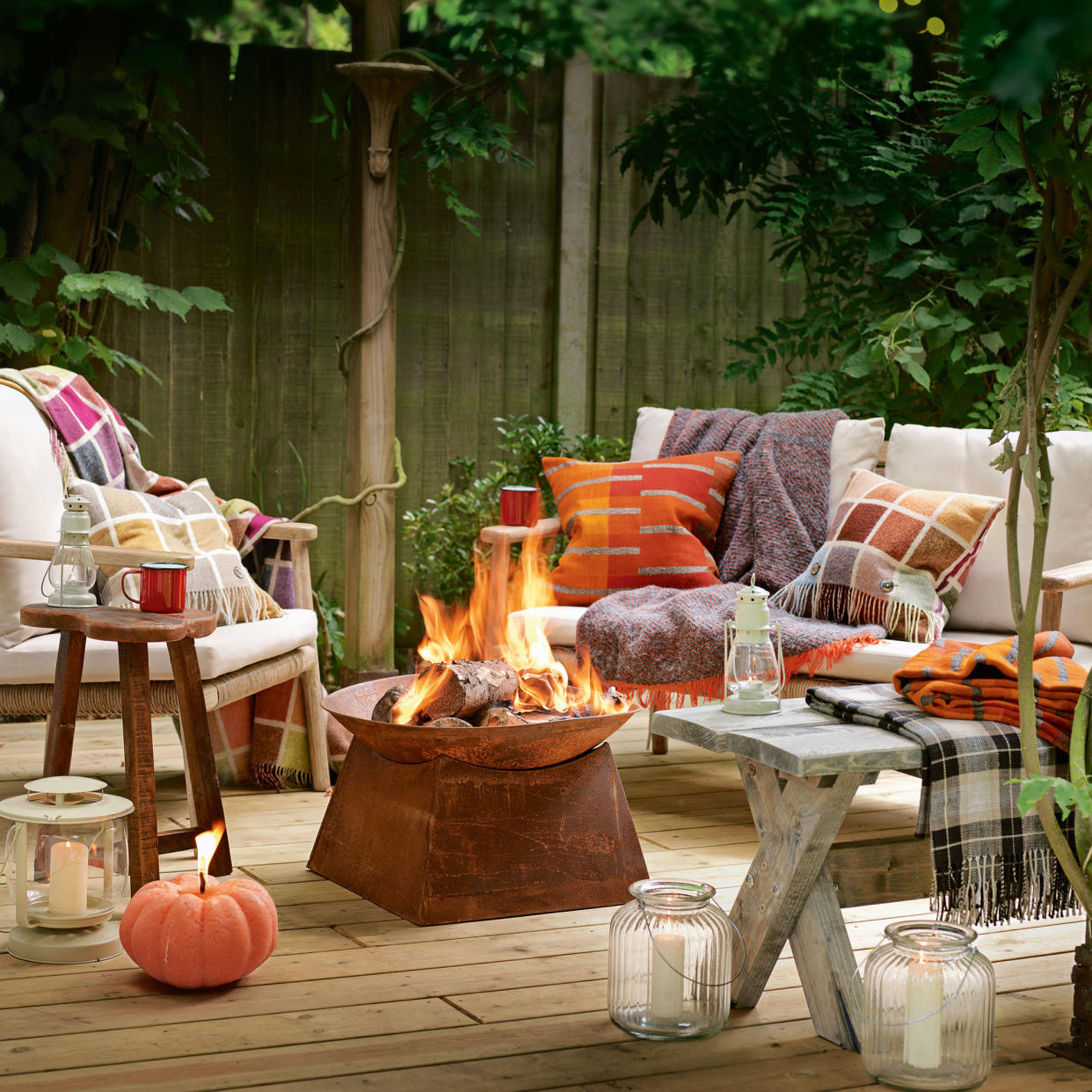  Fire pit on decking with garden seating. 