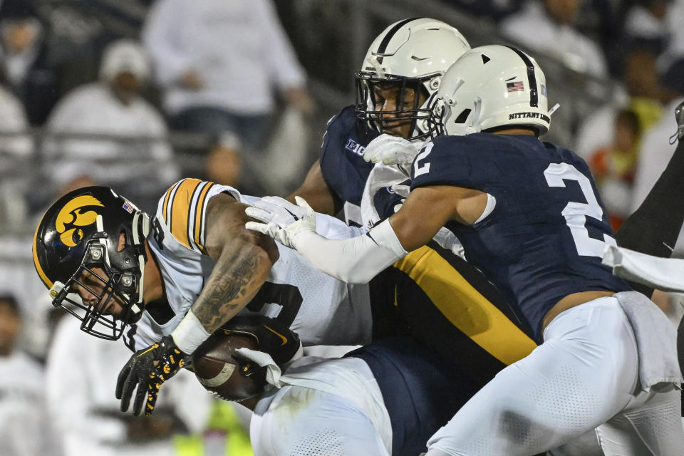 Iowa tight end Erick All (83) is tackled by Penn State safety Keaton Ellis (2) during the first half of an NCAA college football game, Saturday, Sept. 23, 2023, in State College, Pa. (AP Photo/Barry Reeger)