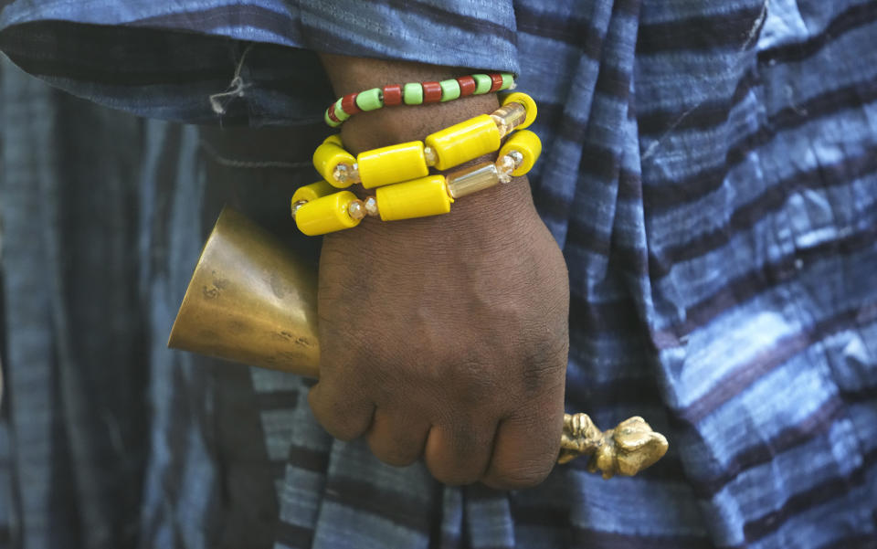 Osunyemi Ifarinu Ifabode, the Osun River chief priest, wears beaded bracelets during an interview in Osogbo, Nigeria, on Monday, May 30, 2022. The river serves as an important “pilgrimage point” for Yoruba people in Nigeria, said Ayo Adams, a Yoruba scholar — especially during the Osun-Osogbo festival, a colorful annual celebration that draws thousands of worshippers and tourists “to celebrate the essence of the Yoruba race.” (AP Photo/Sunday Alamba)