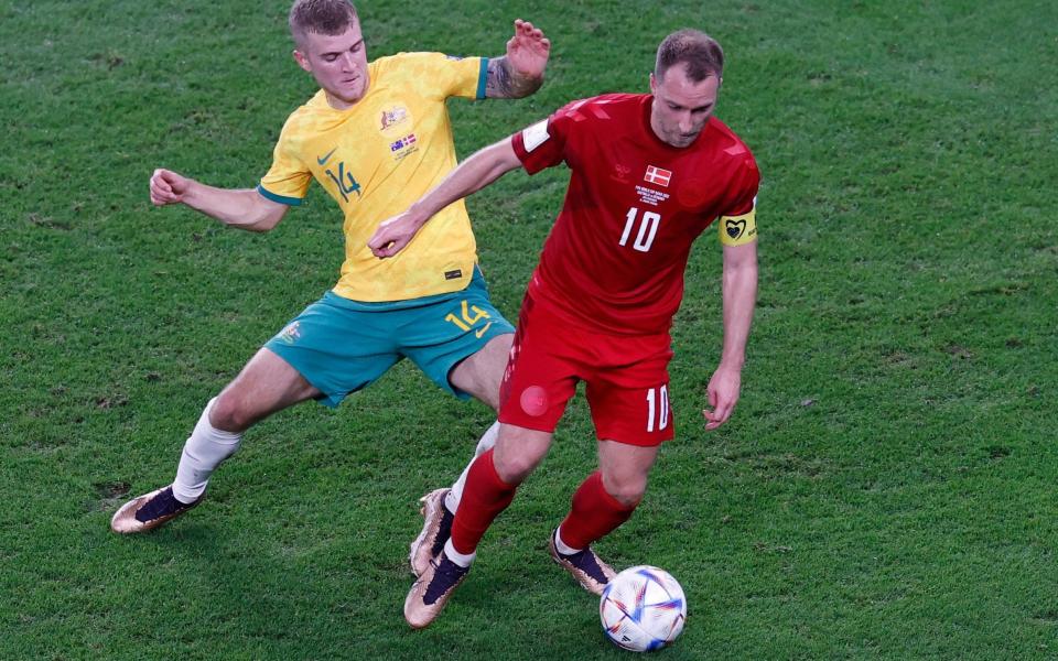  Riley McGree (L) of Australia in action against Christian Eriksen of Denmark during the FIFA World Cup 2022 group D soccer match between Australia and Denmark at Al Janoub Stadium - Rungroj Yongrit/Shutterstock