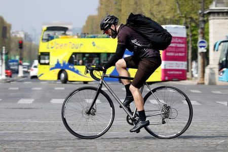 A cycling courier delivers goods, as part of the emerging 'gig economy', in Paris, France, April 4, 2017. Picture taken April 4, 2017. REUTERS/Charles Platiau