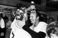 FILE - In this Sept. 17, 1968, file photo, Detroit Tigers pitcher Denny McLain, his head covered in shaving cream, pours a bottle of champagne over the head of teammate Al Kaline as they celebrate their American League pennant victory in the dressing room in Detroit. Al Kaline, who spent his entire 22-season Hall of Fame career with the Detroit Tigers and was known affectionately as “Mr. Tiger,” has died. He was 85. John Morad, a friend of Kaline's, confirmed to The Associated Press that he died Monday, April 6, 2020, at his home in Michigan. (AP Photo/File)