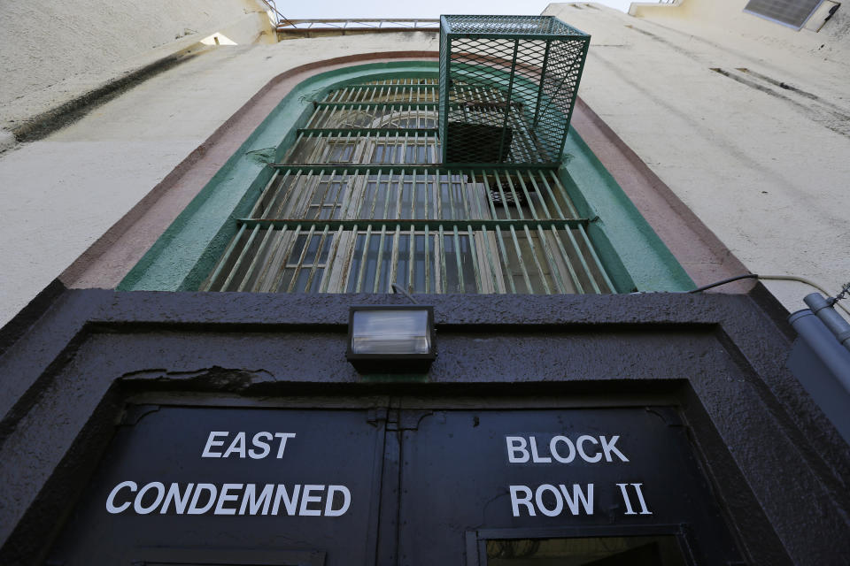 Shown is the entrance to the east block of death row at San Quentin State Prison Tuesday, Aug. 16, 2016, in San Quentin, Calif. The California Labor and Workforce Development Agency confirmed Tuesday, Dec. 1, 2020, that California has sent about $400 million in unemployment benefits to state prison inmates. In all records show 31,000 inmates have applied for benefits and about 20,800 were paid $400 million. A group of local and federal prosecutors said 133 inmates on death row were named in claims. (AP Photo/Eric Risberg, File)