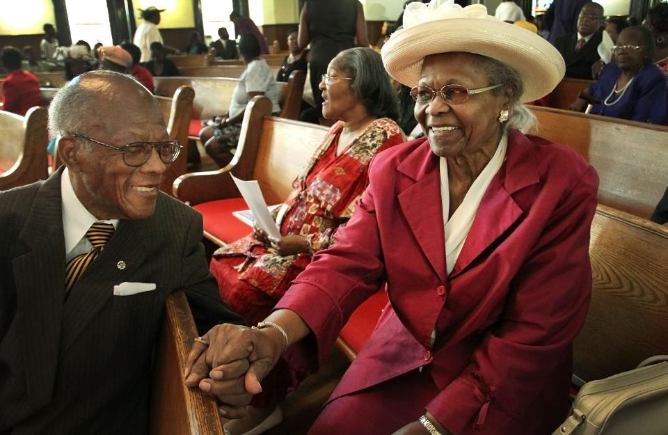 In this 2011 photo taken at Historic Mount Zion AME Church, Sollie Mitchell, left, a church member for 60 years, shares a laugh with Ophelia Toston who had been a member since 1965. They were at a celebration of the church's 145th anniversary.