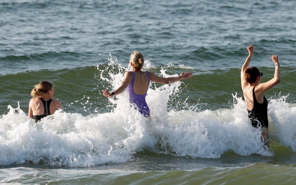 People out for an early dip in the sea at Branksome, Dorset, on May 28 - Splash News/Splash News