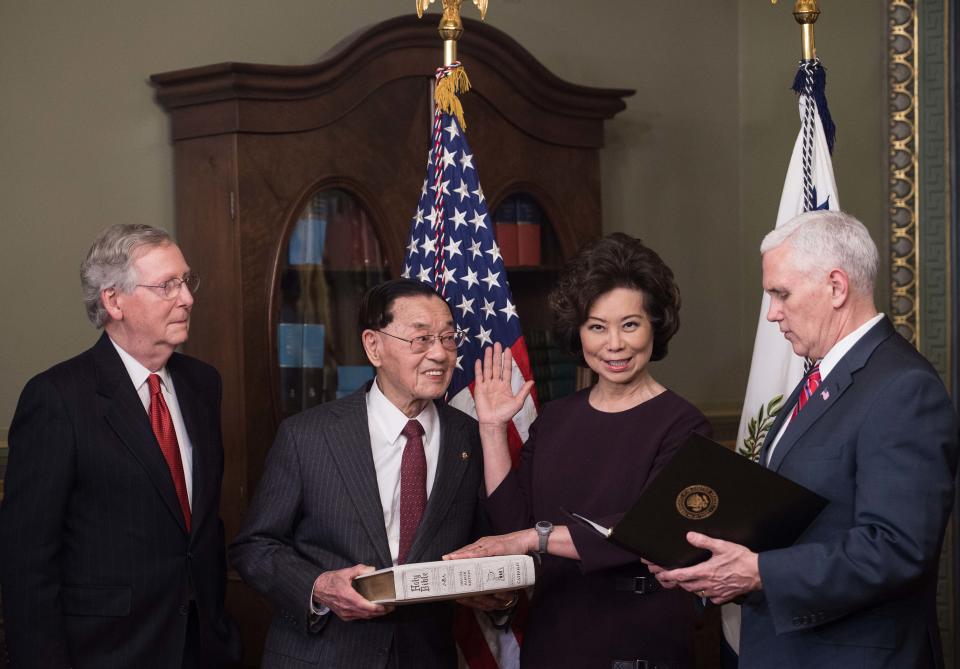 Elaine Chao (2R) is sworn in as US Transportation Secretary by Vice President Mike Pence (R) as her father James Chao (2L) and her husband Senate Majority Leader Mitch McConnell look on in Washington, DC, on January 31, 2017. (Photo: Nicholas Kamm/AFP/Getty Images)