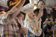 Models wear creations onboard a tram as part of the Missoni Spring-Summer 2020 collection, unveiled during the fashion week, in Milan, Italy, Thursday, Sept. 19, 2019. (AP Photo/Luca Bruno)