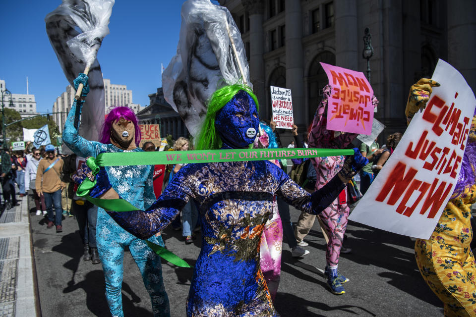 Activists gather and walk through lower Manhattan for the Global Climate Strike protests, Friday, Sept. 23, 2022, in New York. (AP Photo/Brittainy Newman)
