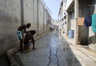 <p>A prisoner combs the hair of a fellow inmate during recreation time inside the National Penitentiary in downtown Port-au-Prince, Haiti, Feb. 13, 2017. About 80 percent of those incarcerated have not been convicted of a crime but are held in prolonged pretrial detention waiting for their chance to see a judge. (Photo: Dieu Nalio Chery/AP) </p>