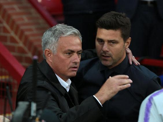 Jose Mourinho and Mauricio Pochettino embrace at Old Trafford (Getty )