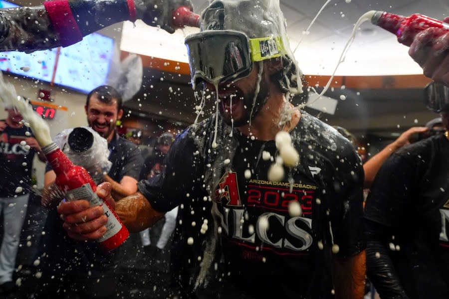 Arizona Diamondbacks pitcher Zac Gallen celebrates with teammates after the Diamondbacks defeated the Los Angeles Dodgers 4-2 in Game 3 to win a baseball NL Division Series, Wednesday, Oct. 11, 2023, in Phoenix. (AP Photo/Ross D. Franklin)