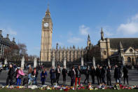 People look at tributes left in Parliament Square following a recent attack in Westminster, London, Britain March 24, 2017. REUTERS/Darren Staples