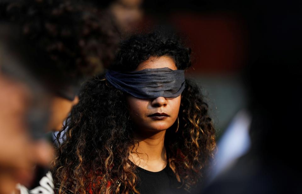 A protestor wearing a blindfold takes part in a protest in solidarity with rape victims and to oppose violence against women in India, in New Delhi, India December 7, 2019. REUTERS/Adnan Abidi - RC2AQD9KST0H