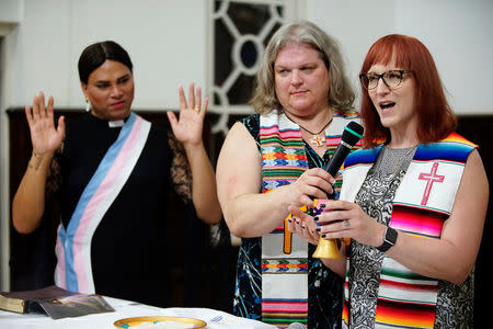 Trans pastors Cindy Bourgeois from Canada (C) and Alexya Salvador from Brazil listen to trans Baptist reverend Allyson Robinson from the U.S. during a mass in Matanzas, Cuba, May 5, 2017. Picture taken on May 5, 2017. REUTERS/Alexandre Meneghini