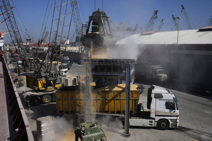 Trucks being filled with Ukrainian corn from the ship AK Ambition, sailing under the flag of Panama at Tripoli seaport, in Tripoli, north Lebanon, Monday, Sept. 26, 2022. A ship carrying thousands of tons of corn and vegetable oil arrived in northern Lebanon Monday from war-ravaged Ukraine, the first of its kind since Russia's invasion of its neighbor began seven months ago. (AP Photo/Hassan Ammar)