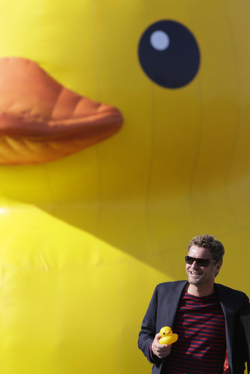 Dutch conceptual artist Hofman poses for a photo in front of his work Rubber Duck at the Summer Palace in Beijing