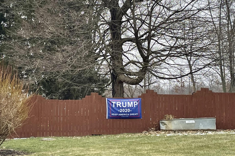 This photo made on Jan. 25, 2021 shows one of the Trump 2020 flags and insignia that are displayed on lawns and property in the village of Woodstock, Ohio. The village with less than 300 people was recently the scene of the arrest of two of its residents for what the FBI calls their plot and participation in the deadly U.S. Capitol breach on Jan. 6. (AP Photo/Farnoush Amiri)