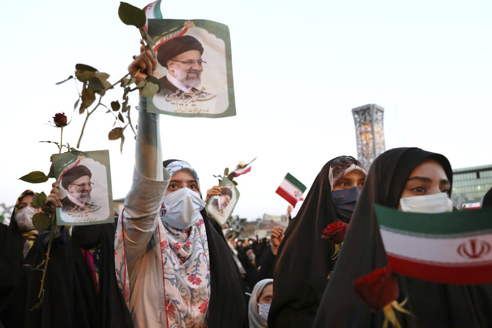 Supporters of Iranian president-elect Ebrahim Raisi celebrate after he won the presidential election in Tehran, Iran, Saturday, June 19, 2021. Initial results released Saturday propelled Raisi, a protege of the country's supreme leader, into Tehran’s highest civilian position. The vote appeared to see the lowest turnout in the Islamic Republic’s history. (AP Photo/Ebrahim Noroozi)