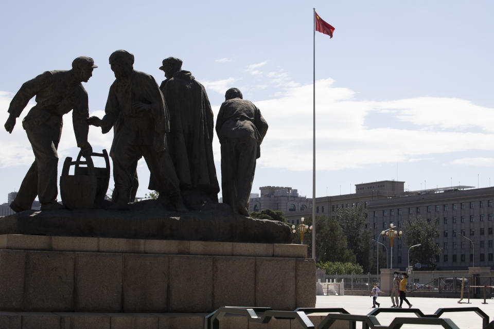 Visitors to the military museum walk past a sculpture in Beijing on Thursday, Sept. 3, 2020. China on Thursday commemorated the 75th anniversary of the end of World War II in the Pacific, during which it endured a brutal invasion and occupation of much of its territory by Japan. (AP Photo/Ng Han Guan)