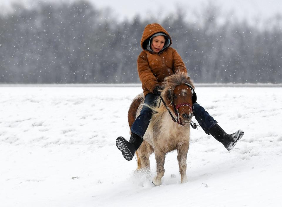 A young participant rides on a pony through the snow as part of the Dakota 38+2 Memorial Ride on Wednesday, December 14, 2022, east of Howard, SD. The horseback journey stretches from the Lower Brule Sioux Tribe to Mankato, MN, commemorating Dakota warriors who died in the largest single-day mass execution in the country on Dec. 26, 1862.