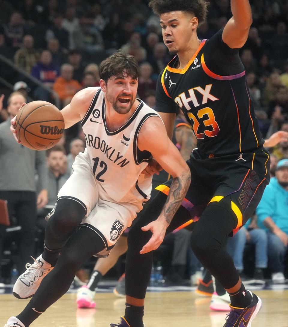 Jan 19, 2023; Phoenix, Arizona, USA; Phoenix Suns forward Cameron Johnson (23) defends Brooklyn Nets Joe Harris (12) at Footprint Center. Mandatory Credit: Joe Rondone-Arizona Republic