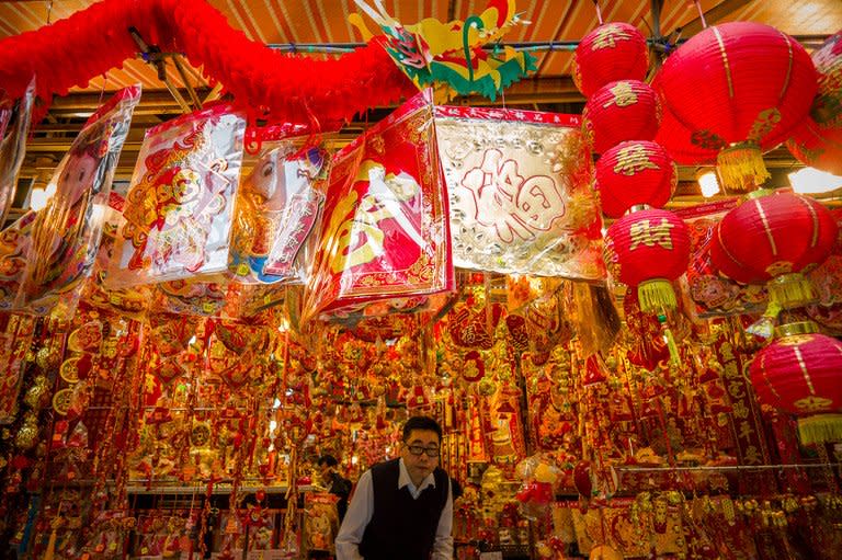 A man exits a shop selling Chinese New Year decorations, in Hong Kong, on February 5, 2013. Astrologers say this year's snake is identified with the element of water -- symbolising fear -- that sits on top of the fire element, representing joy and optimism