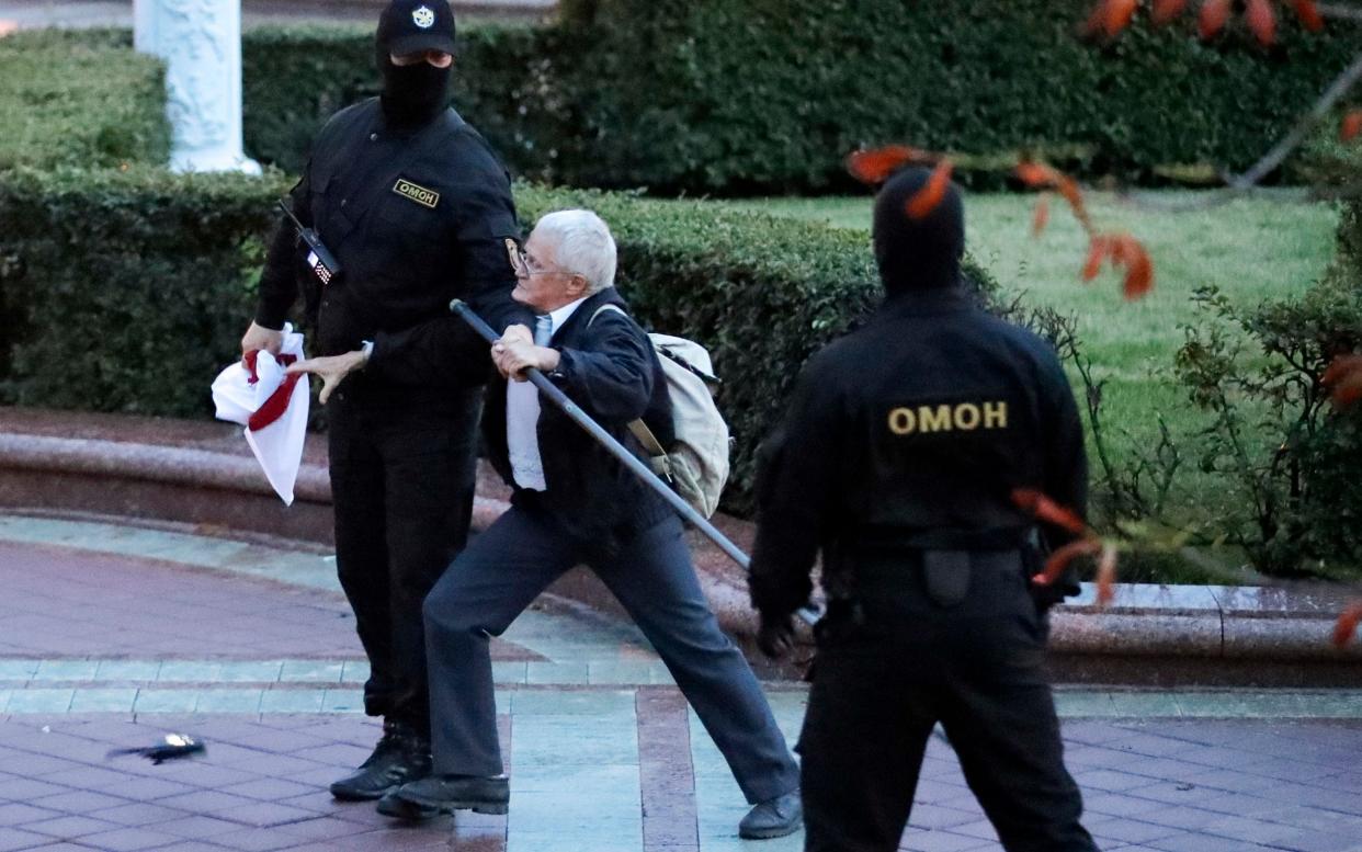 Opposition activist Nina Baginskaya, 73, center, struggles with police during a rally at Independence Square in Minsk - AP Photo/Sergei Grits