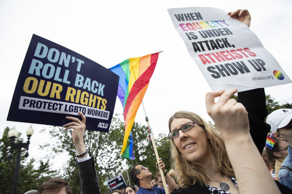 FILE - In this Oct. 8, 2019, file photo, transgender woman Alison Gill from Maryland, joins LGBT supporters in front of the U.S. Supreme Court, Tuesday, Oct. 8, 2019, in Washington. The Supreme Court has ruled that a landmark civil rights law protects gay, lesbian and transgender people from discrimination in employment. It's a resounding victory for LGBT rights from a conservative court. (AP Photo/Manuel Balce Ceneta, File)