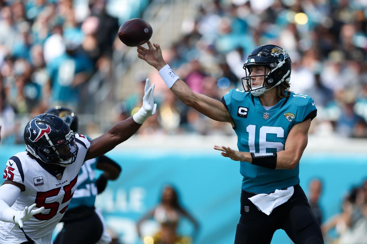 Jacksonville Jaguars quarterback Trevor Lawrence (16) is pressured by Houston Texans defensive end Jerry Hughes (55) in the first quarter at TIAA Bank Field.