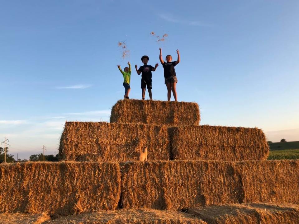 Kids climb the hay bale mountain at Our Farm near Parker, South Dakota. Our Farm is a new family-run fall destination spot for families and kids.