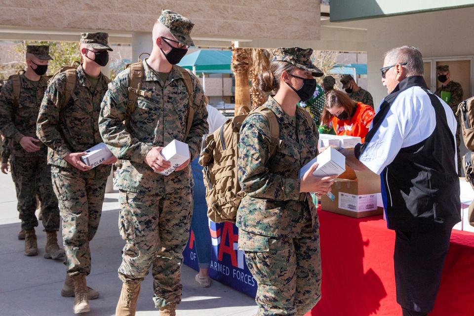 AFAF volunteers thank troops for their service through Thanksgiving barbecue lunch and gifts.