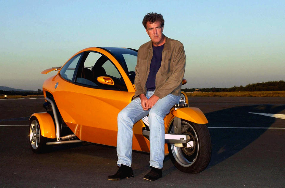 Top Gear presenter Jeremy Clarkson leans on a Carver, a tilting three-wheeled vehicle, at Dunsfold Park, Surrey.  (Photo by Chris Young - PA Images via Getty Images)