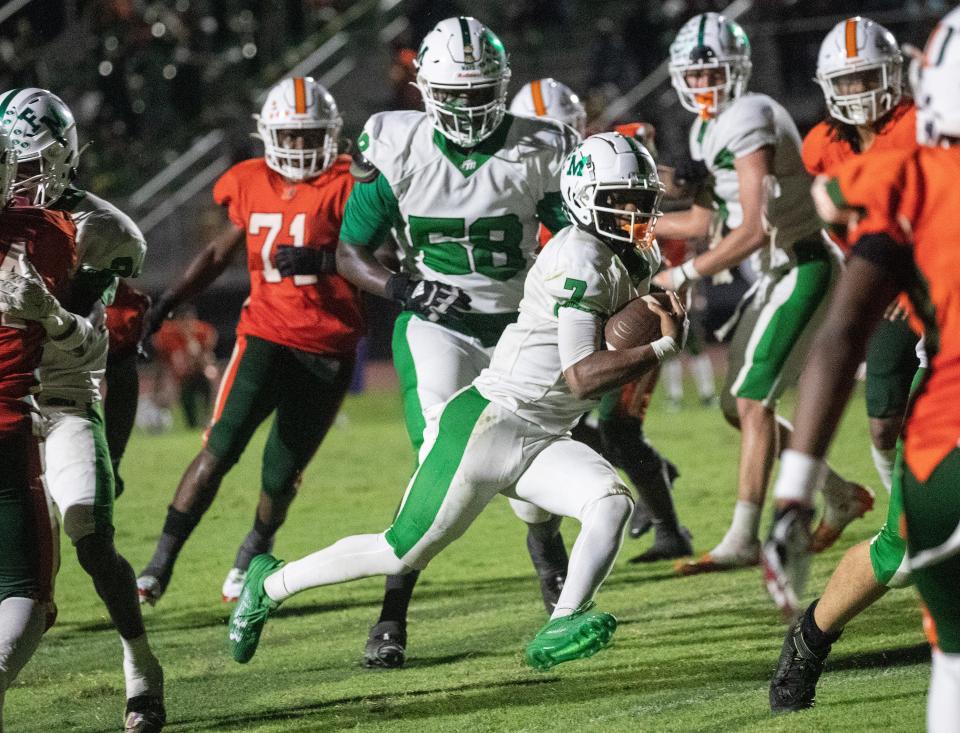 Fort Myers quarterback Chris McFoley runs in a touchdown in overtime on Friday, Sept. 15, 2023, at Dunbar High School. Dunbar won 40-39 in double overtime after a two-point conversion.