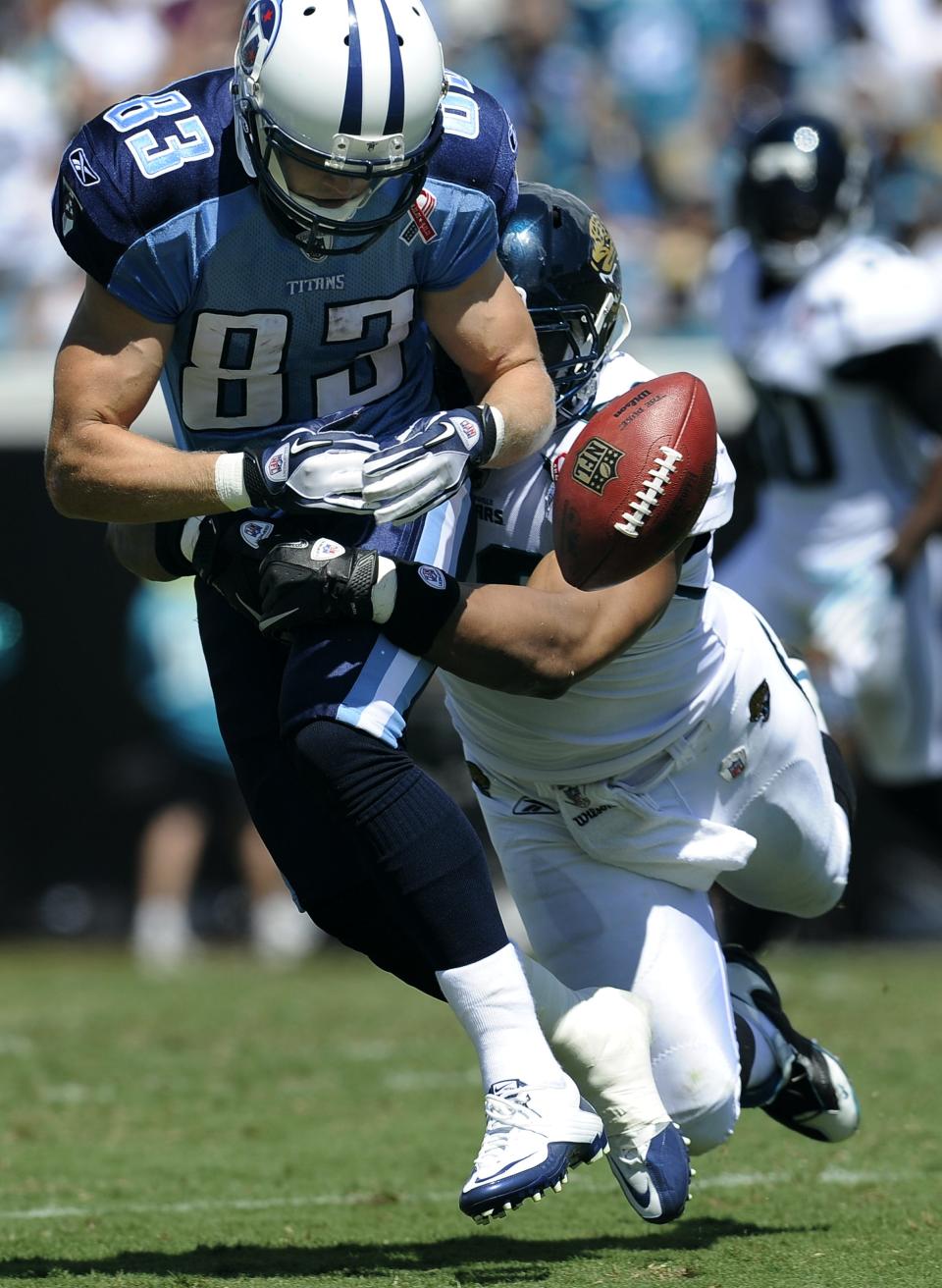 Tennessee Titans wide receiver Marc Mariani (83) lets a pass bounce off of his hand as he is defended by Jacksonville Jaguars linebacker Daryl Smith (52) in the third quarter during their game at EverBank Field Sunday, Sept. 11, 2011 in Jacksonville, Fla.