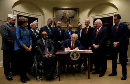 U.S. President Donald Trump signs S.544, the Veterans Choice Program Extension and Improvement Act, at the White House in Washington, U.S., April 19, 2017. REUTERS/Kevin Lamarque