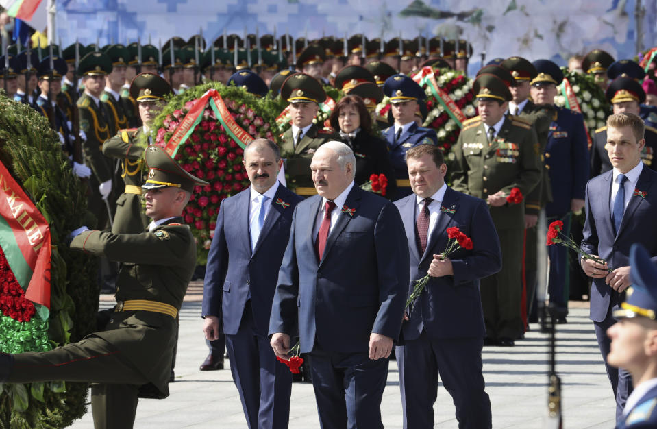 FILE - In this Sunday, May 9, 2021 file photo, Belarus President Alexander Lukashenko, centre, surrounded by his sons Dmitry, second right, Victor, centre left, and Nikolai, right, attends wreath laying ceremony at Victory Square in Minsk, Belarus,marking the 76th anniversary of the end of World War II in Europe. The coronavirus pandemic has upended life around the globe, but it has hasn’t stopped the spread of authoritarianism and extremism. Some researchers believe it may even have accelerated it, but curbing individual freedoms and boosting the reach of the state. Since COVID-19 hit, Hungary has banned children from being told about homosexuality. China shut Hong Kong’s last pro-democracy newspaper. Brazil’s president has extolled dictatorship. Belarus has hijacked a passenger plane. A Cambodian human rights lawyer calls the pandemic “a dictator's dream opportunity.” But there are also resistance movements, as protesters from Hungary to Brazil take to the streets to defend democracy. (Maxim Guchek/BelTA Pool Photo via AP, File)