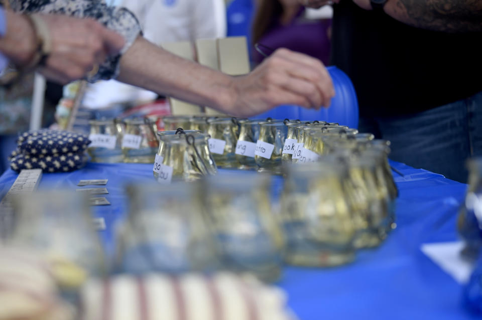 Voters use beads to make their selections among Democratic presidential candidates ahead of speeches at the Galivants Ferry Stump on Monday, Sept. 16, 2019, in Galivants Ferry, S.C. The stump is advertised as one of the oldest traditional campaign speech events in the country. (AP Photo/Meg Kinnard)