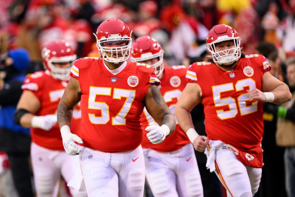 Kansas City Chiefs offensive tackle Orlando Brown Jr. (57) leads his offensive line teammates, including Chiefs guard Joe Thuney (62), onto the field for warmups before the NFL AFC Championship playoff football game against the Cincinnati Bengals, Sunday, Jan. 29, 2023 in Kansas City, Mo.