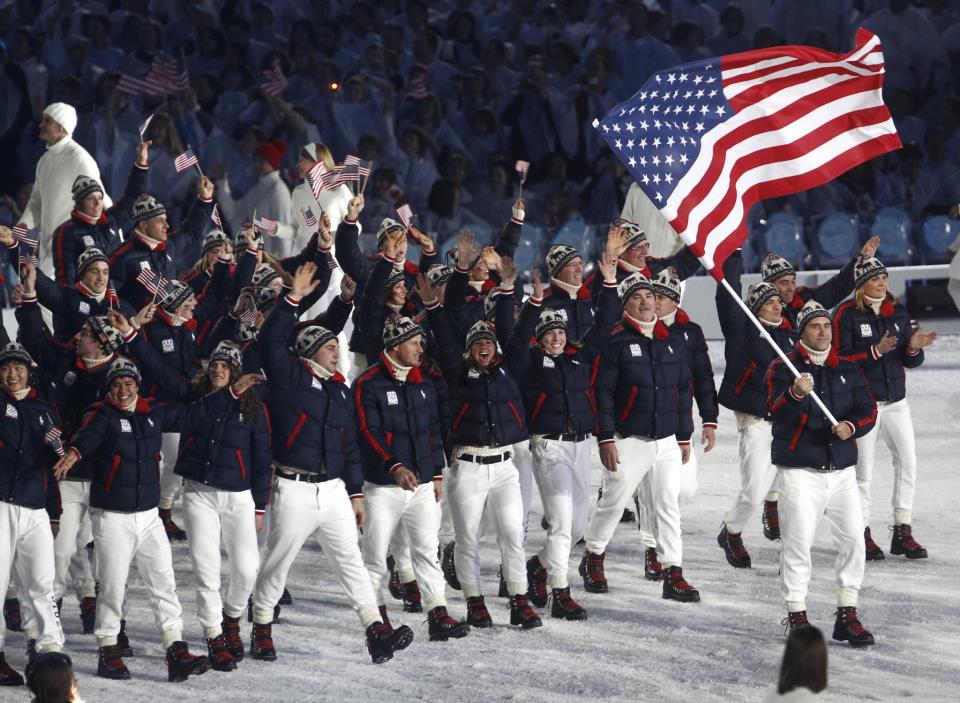 <p>Team USA's winter Olympians rocked navy blue and red puffer coats with white pants and knitted hats at the Vancouver Olympics. (AP) </p>