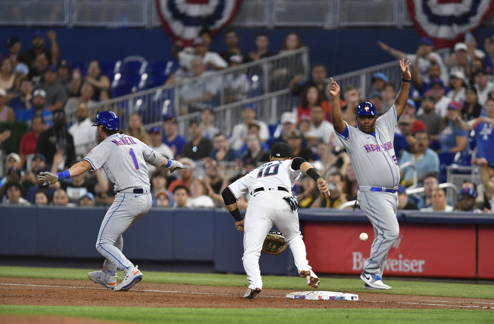 New York Mets' Jeff McNeil (1) is safe at first base after Miami Marlins first baseman Yuli Gurriel (10) dropped the ball during the first inning of a baseball game, Sunday, April 2, 2023, in Miami. (AP Photo/Michael Laughlin)