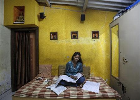 Riteesha Tambe, an 18-year-old college student, poses inside her house in Mumbai March 11, 2014. REUTERS/Danish Siddiqui