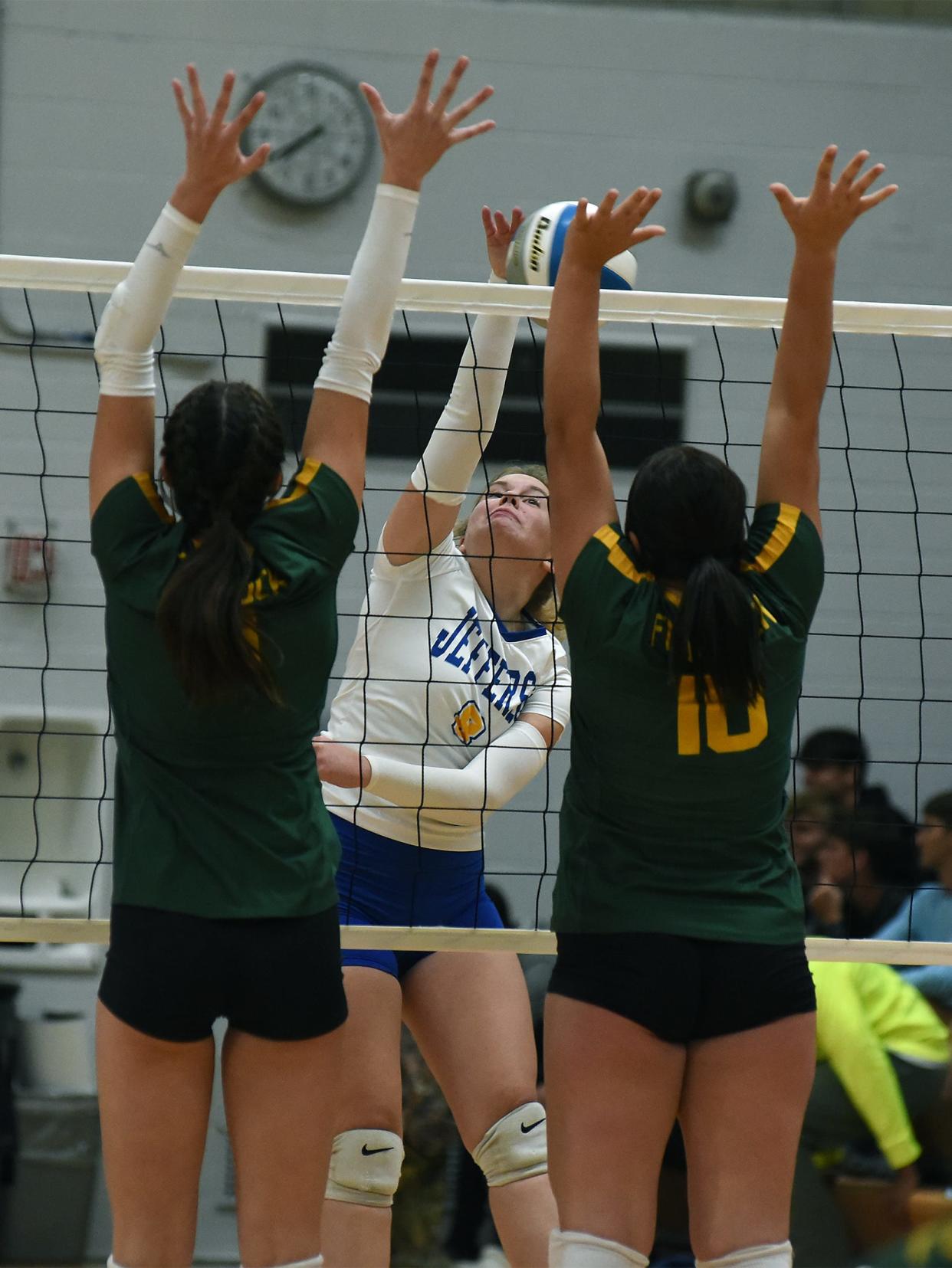 Meagan Middleton of Jefferson goes up to spike past the Flat Rock blockers Sarah Giroux and Jaclynn Motyka as the Bears won in five sets 25-20, 25-23, 21-25, 22-25, 15-11 Monday, October 9, 2023.