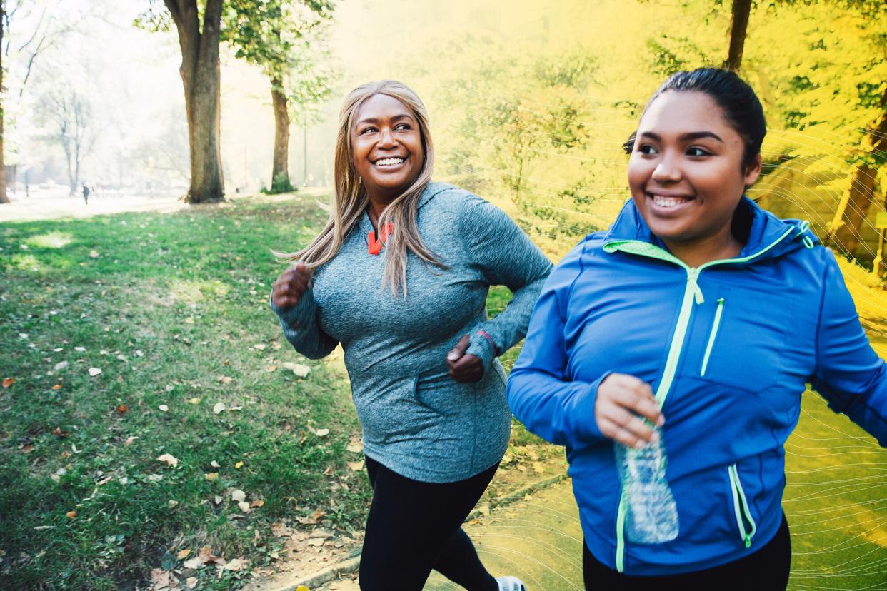 two women running together outside