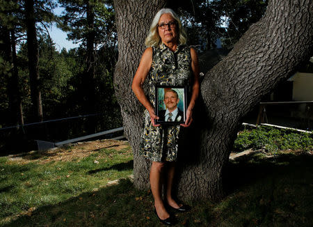 Nancy Schrock holds a picture of her late husband Thomas at her home in Oak Glen, California, July 26, 2016. Picture taken July 26, 2016. To match Special Report USA-TASER/911 REUTERS/Mike Blake