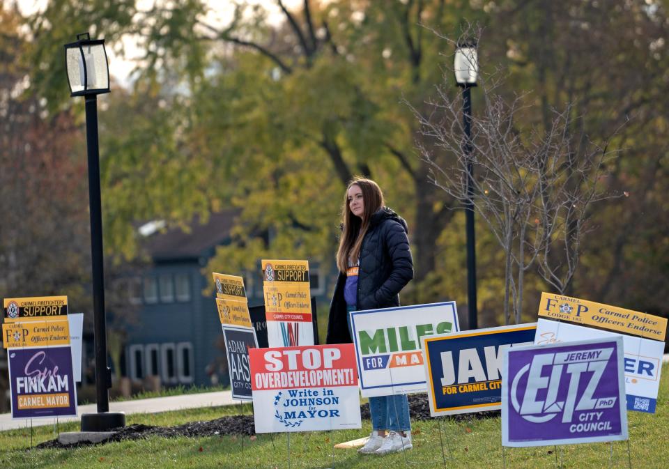 Dawn Bonnell supports Sue Finkam, Carmel mayoral candidate, as she waits for voters to pass her on their way to vote, on election day Tuesday, Nov. 7, 2023 at Brookshire Golf Club in Carmel, Ind. No campaigning is allowed past this point.