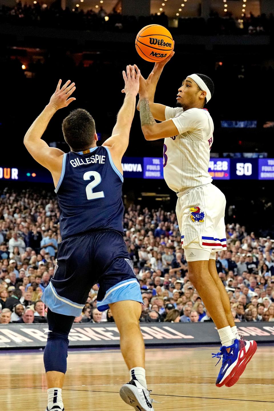 Kansas guard Dajuan Harris Jr. takes a shot against Villanova guard Collin Gillespie during the second half of a Final Four game at the NCAA tournament this past season on April 2, 2022 in New Orleans.